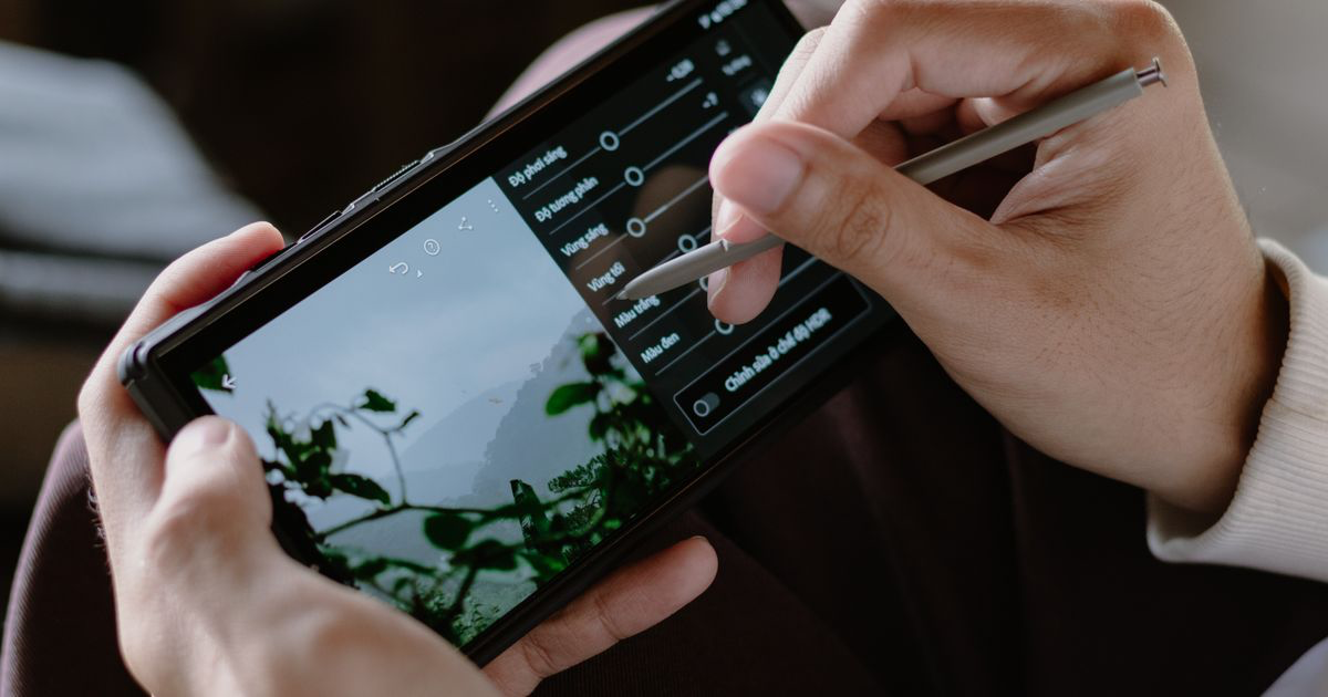 A person editing a photo on a smartphone, weighing up Facetune for nail photos