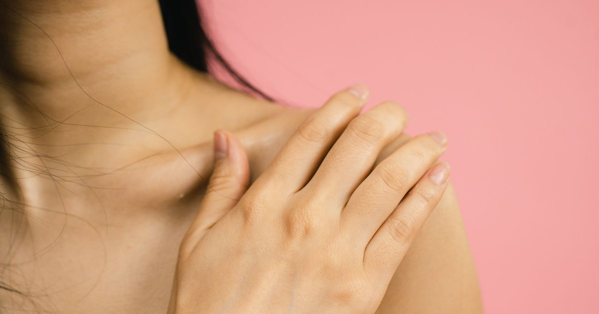Close-up of a hand with a soft pink manicure on a pink backdrop, the low-contrast tones that matter when editing ombré nail photos