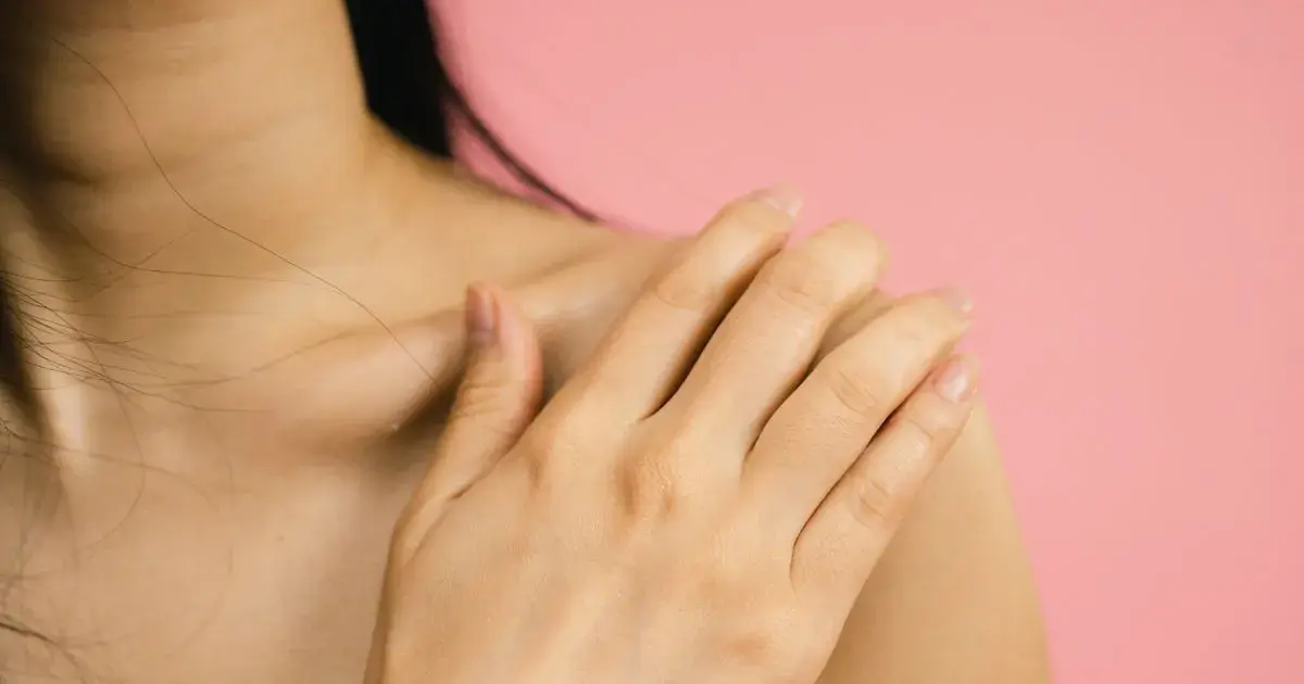 Close-up of a hand with a soft pink manicure on a pink backdrop, the low-contrast tones that matter when editing ombré nail photos