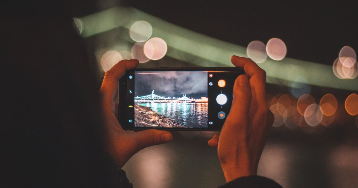 Hands holding a smartphone taking a photo, the moment to lock focus and exposure for nail photos