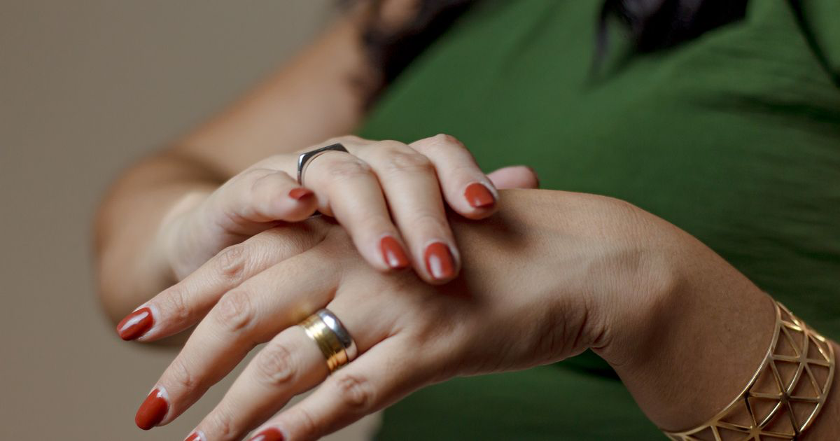 Close-up of a pair of hands with jewellery and painted nails, the kind of clean framing that makes nail photos look professional